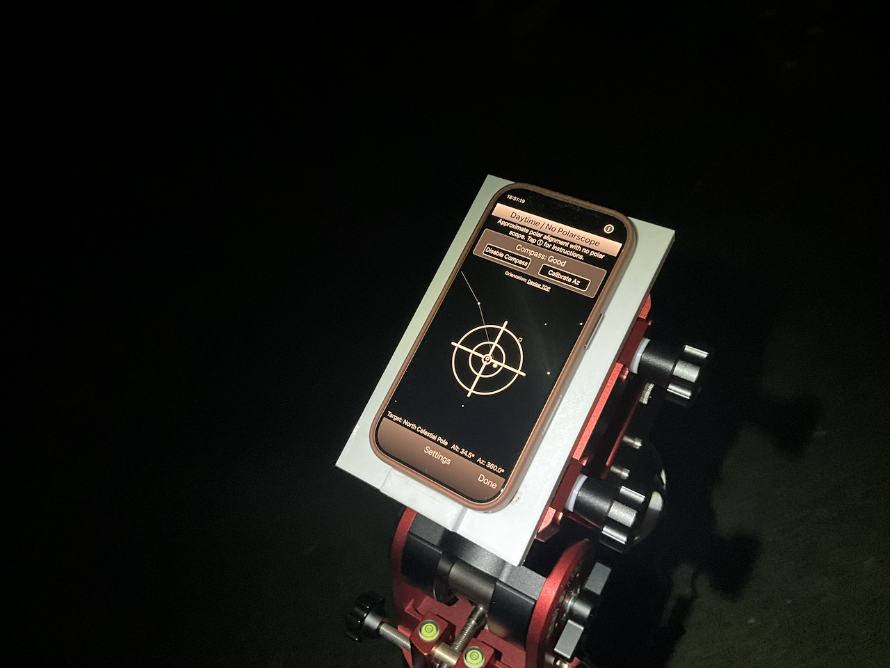 The phone on the mount with the polar alignment app showing the mount lined up